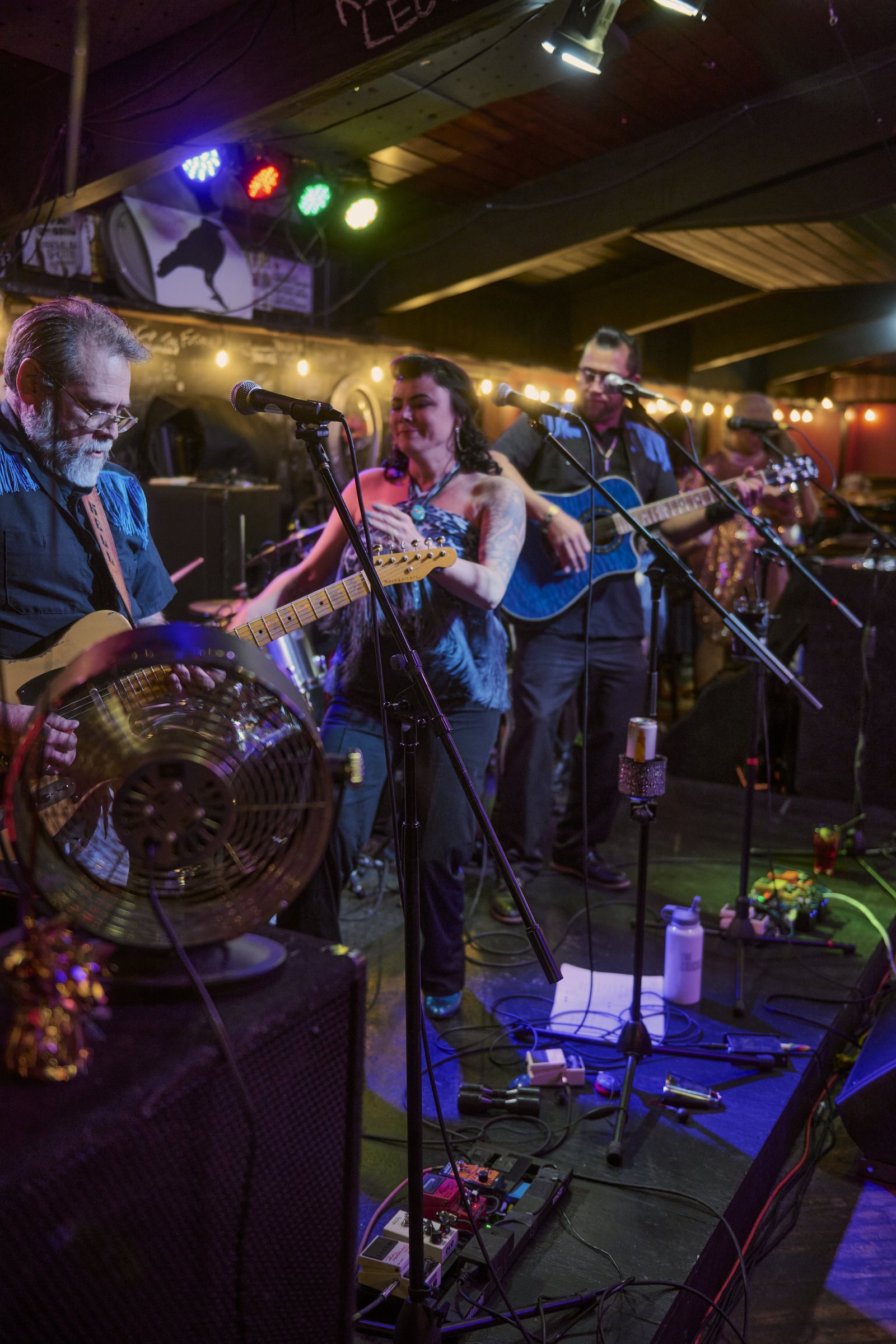 The Shameful Hussies performing on stage at a HeARTS community event